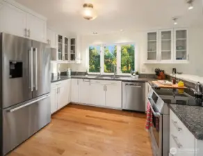 All appliances replaced in 2025. Stone countertops, lots of cabinetry and a lovely view from all sides. Separate pantry closet is adjacent to this space.