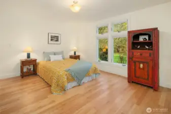 Large second bedroom on the western end of the bedroom wing. Room feels light and bright and spacious. These floors are gorgeous!