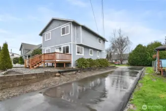 Driveway to rear with two designated parking spots