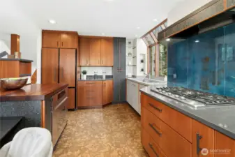 Beautiful custom kitchen was designed by prominent kitchen designer Richard Landon. Premium cherry cabinetry, custom-made glass door accents and beautiful Jatoba island. Fan above the cooktop pulls out and is a powerful performer. Flooring is cork for durability and beauty.