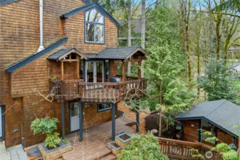 Wisteria-draped deck off kitchen, lower deck and charming outbuilding.
