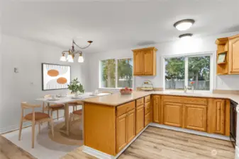 Virtual staging shows how furniture could look in this space. Solid surface counters, an abundance of cabinets and soft close drawers.