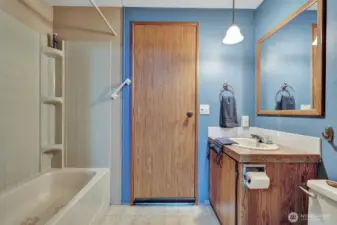 Full guest bathroom offers tub surround with built in shelves for shampoo etc. Also, there is an access door from the utility room into this bathroom for your convenience.