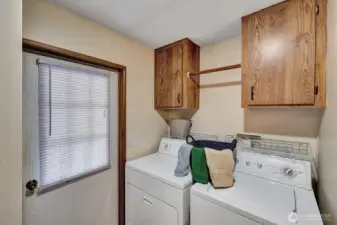Utility room access door to the back yard area. Storage cabinet above the washer and dryer for all your laundry supplies. Corner closet for linens or cleaning supplies as there is an access door the the full bath here also.