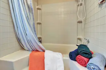Garden tub in the primary ensuite and commode are in private room. Built in linen cabinet for all your bathing necessities.