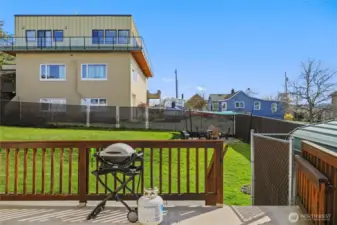 Main deck leading to fully fenced backyard