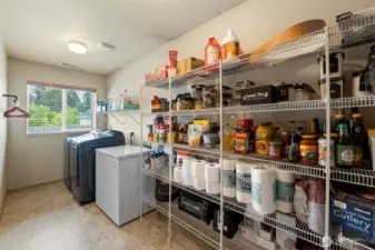 Enjoy the convenience of a spacious walk-in pantry and easy access to the laundry room, all just off the kitchen for added functionality and storage.