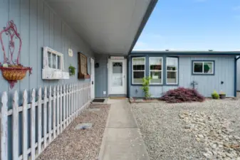 Covered front walkway adds curb appeal and protection from the elements at the home’s entrance.