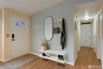 Bright entryway with NEW LVP flooring throughout the main areas and a functional drop zone for coats and accessories. (Virtually staged)
