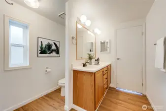 You'll not only love the NEW LVP flooring but also the privacy wall between sink & toilet. (Virtually staged)