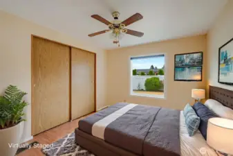 Spacious second bedroom with ceiling fan, large closet, and great natural light—perfect for guests, office or hobbies. (Virtually staged)