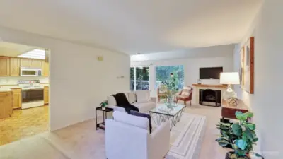 This living room is filled with natural light thanks to the glass sliding door to the backyard, creating a seamless indoor-outdoor flow