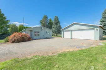 Detached 3-car garage with gravel floor and insulated ceiling.