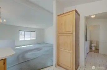 Kitchen looking towards living room to the left and guest bathroom to the right.