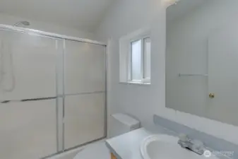 Primary bathroom with large walk-in shower.