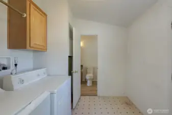 Laundry room that connects to guest bathroom.