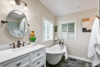 Remodeled primary bathroom with tub and shower.