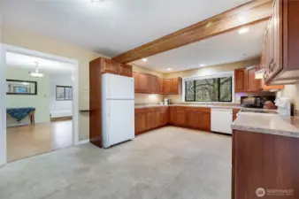 Remodeled kitchen opens to the dining room that boasts original hardwood floors,