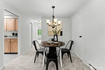 Bright and inviting dining area with plush carpet and modern chandelier
