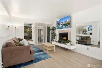 Spacious living room with nice updated flooring and a perch for your art, your plants, or your cat to enjoy.