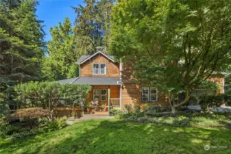 Mature gardens surround this home.