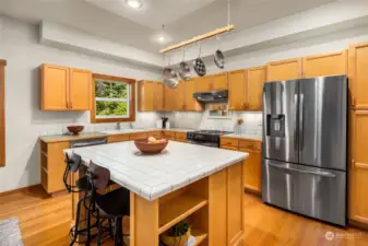 The hardwood floors continue into the kitchen with a large work island which is a great eat-in space.