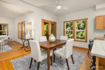 Dining room with large windows and double doors to the deck