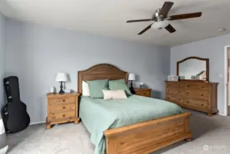 Primary bedroom with ceiling fan.