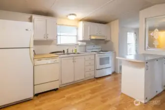 Step into the kitchen with preparation island, window over the sink, and lots of cabinet space.