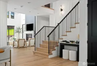 Metal and wood railing accent the wood steps to upstairs area