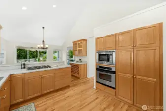Another view of the kitchen, vaulted ceiling and even a place to store glassware and beverages...