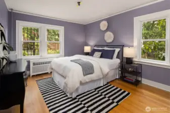 The first bedroom, which gets great east-facing light from its windows onto the building's private, secure patio.