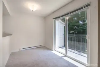 Sliding doors lead to deck with storage closet.