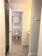 Master bathroom with closets on both sides.