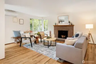 Gleaming hardwoods, mini split for AC,  wood burning fireplace and ample natural light are this home’s welcome to all visitors.