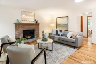 A wood-burning fireplace stands at the ready to warm and hearten all who sit by it.