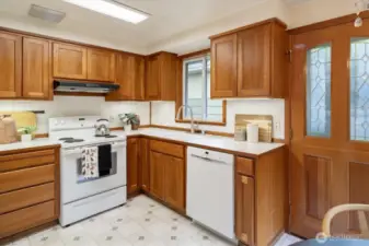 The kitchen features cherry cabinets, under cabinet lighting and all appliances stay.