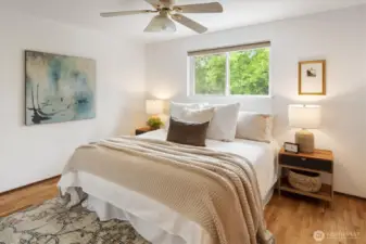 The first of three bedrooms beguiles with its light, space, and shining floors.