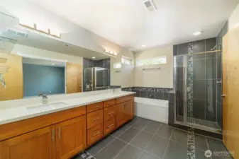 Beautiful, expansive primary bathroom with elegant finishes and ample space for comfort and relaxation