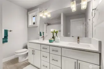 Primary bathroom ensuite has double vanity and a tub