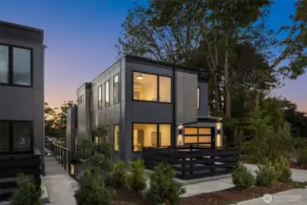 As dusk settles, the home’s sleek design comes alive with ambient light cascading through tall windows. A perfect balance of privacy and openness, framed by nature and Mount Baker’s quiet charm.