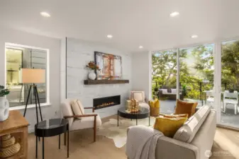 Gather and unwind in the heart of the home—anchored by a striking gas fireplace, generous windows, and an effortless connection between living, dining, and kitchen spaces that make every day feel elevated.