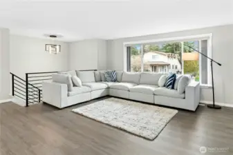 Light-filled living room with NEW Luxury Vinyl Plank Floors and large picture window