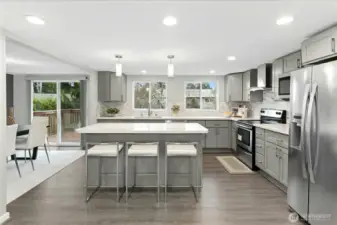 Updated kitchen with quartz countertops, stainless steel appliances and open-concept layout.