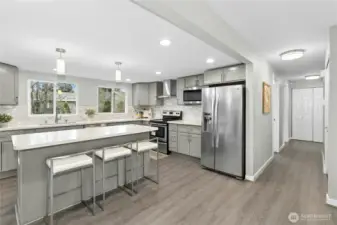 Modern kitchen with quartz counters and stainless steel appliances.