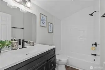 En Suite Full Bath w/Custom Tiled Shower, New Vanity, Laminate Floors and fixtures.