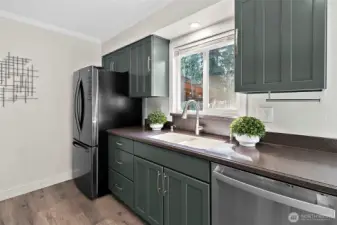 Kitchen sink window open to deck area and over looks the backyard.