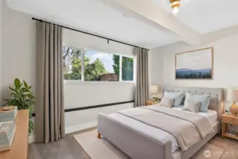 Virtually staged photo. Third bedroom, located downstairs.