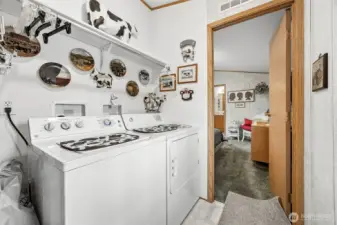 Laundry room just outside the primary suite.