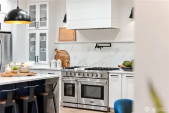 Professional range and gorgeous custom hood with pot filler!